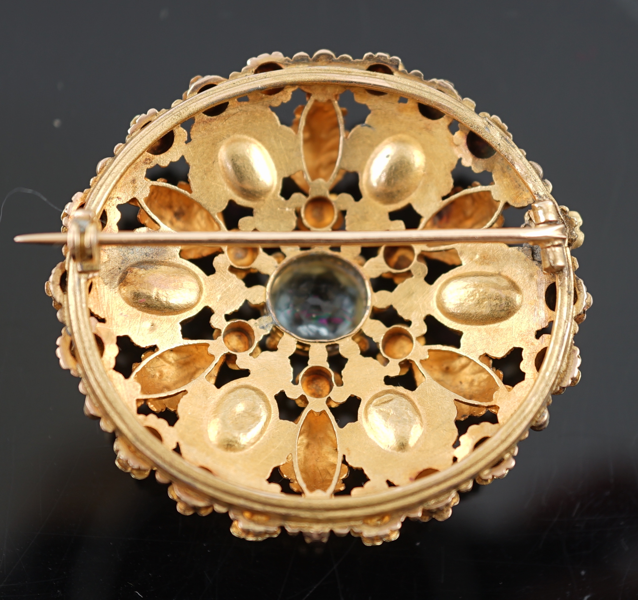An early 20th century continental two colour gold, aquamarine and foil backed pink stone cluster set circular brooch
